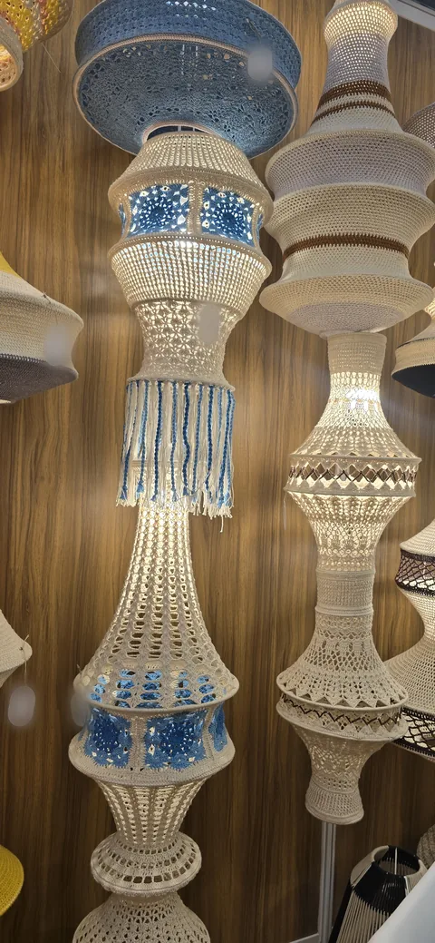 Tall cream crochet pendant lamps with blue and white bands and tassels, hanging at our stall, IHGF Delhi Fair Spring 2026.