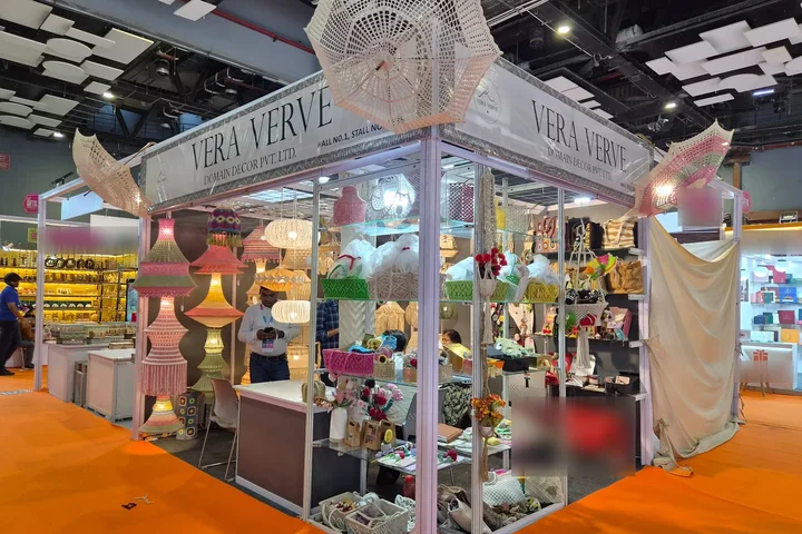 The Vera Verve corner stall at Gifts World Expo 2026, with crochet umbrellas, lamps and baskets.