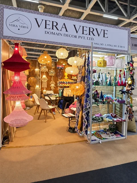 The Vera Verve stall in Hall 3 at IHGF Delhi Fair Spring 2026, with red and pink crochet lamps at the entrance.