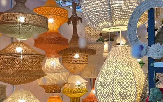 Crochet pendant lamps in yellow, orange, cream and natural yarns lit up inside the Vera Verve stall at IHGF Delhi Fair Autumn 2026.