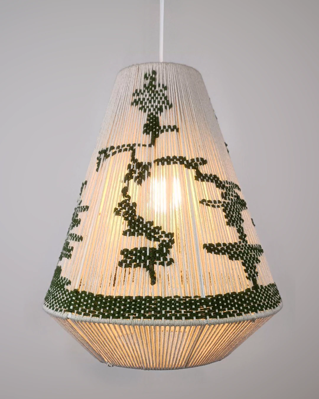 Tapered pendant lamp with cream cordwork and dark green woven motifs.